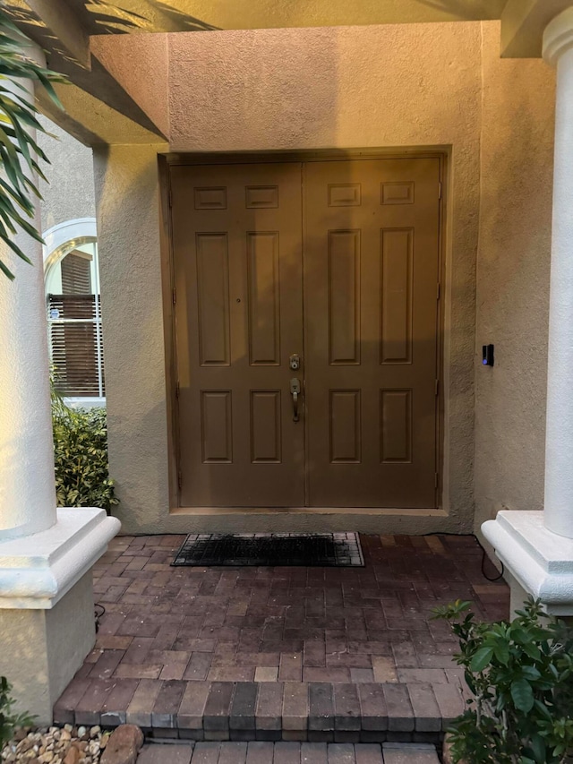 view of exterior entry with a porch