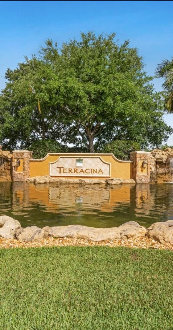 community / neighborhood sign featuring a water view