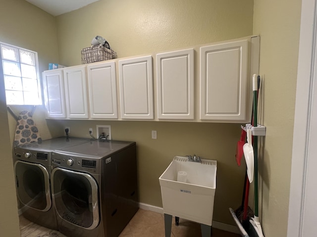 washroom featuring cabinets, sink, light tile patterned floors, and washer and dryer