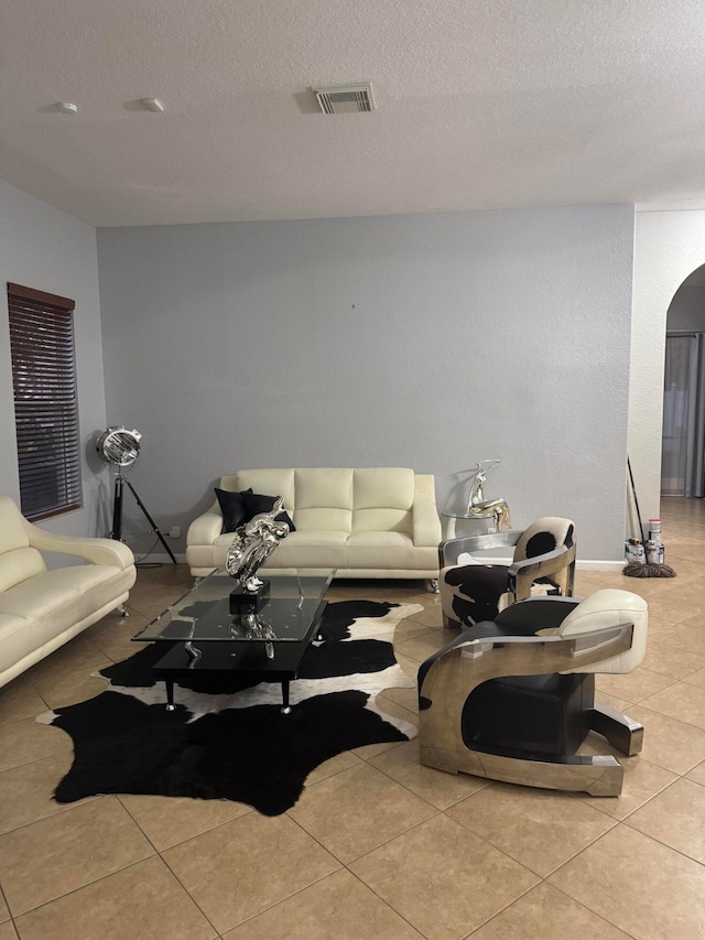 living room with light tile patterned floors and a textured ceiling