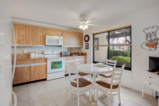 kitchen with ceiling fan, light tile patterned floors, backsplash, and white appliances