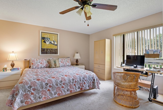 bedroom featuring carpet, ceiling fan, and a textured ceiling