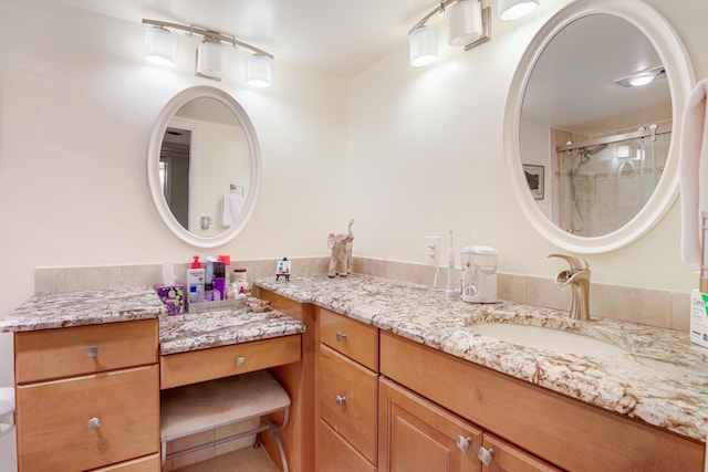 bathroom with vanity and a shower with shower door