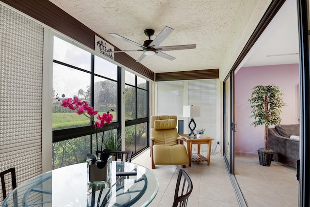 sunroom / solarium featuring ceiling fan