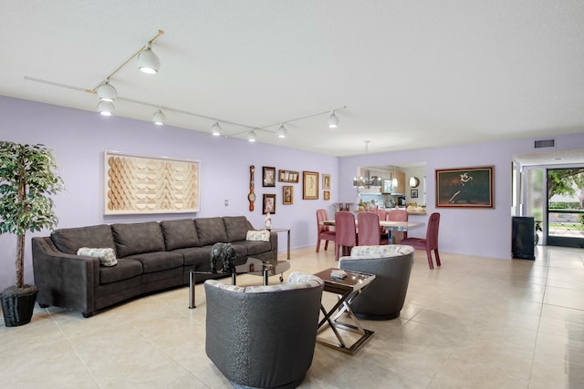 tiled living room featuring track lighting