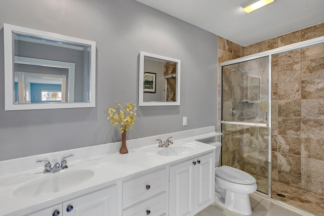 bathroom with vanity, toilet, tile patterned floors, and walk in shower