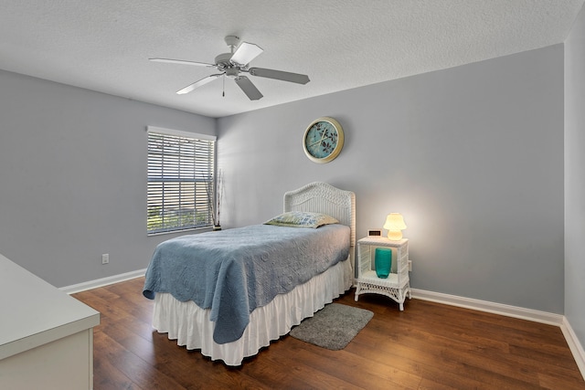 bedroom featuring a textured ceiling, dark hardwood / wood-style floors, and ceiling fan