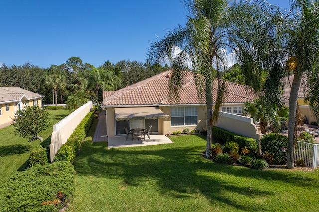 back of house featuring a patio and a lawn