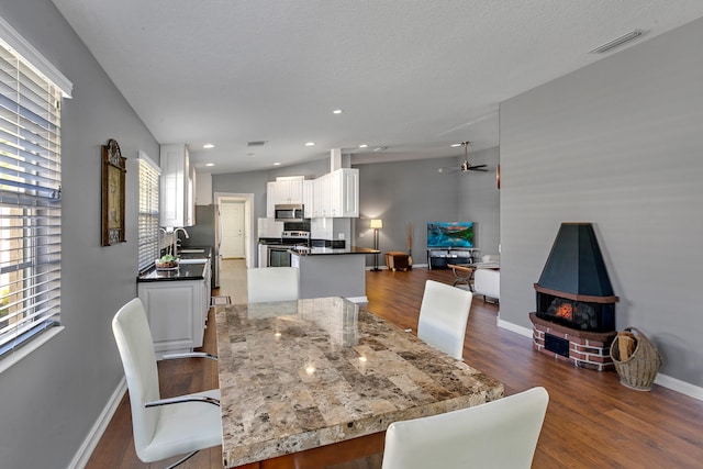 dining space featuring dark hardwood / wood-style floors and a textured ceiling