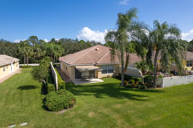 back of property featuring a patio and a lawn