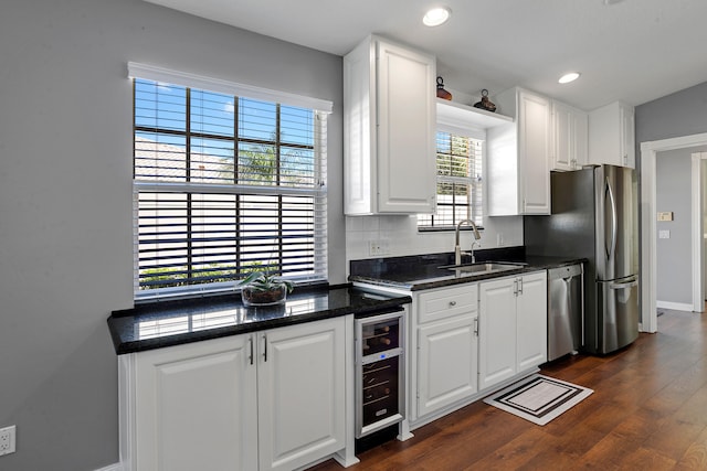 kitchen featuring dishwasher, white cabinets, dark wood-type flooring, and beverage cooler