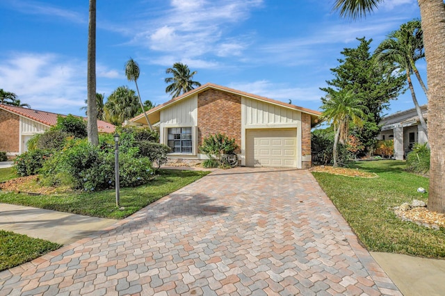 ranch-style home with a front lawn and a garage