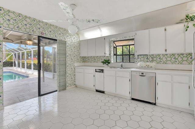 kitchen featuring ceiling fan, sink, white cabinets, and dishwasher