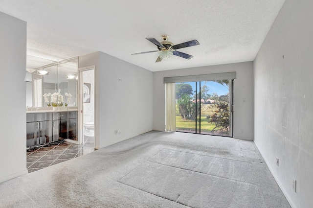 interior space featuring ceiling fan, a textured ceiling, and carpet flooring