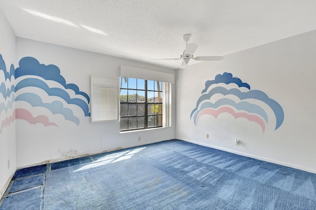 carpeted spare room with ceiling fan and a textured ceiling