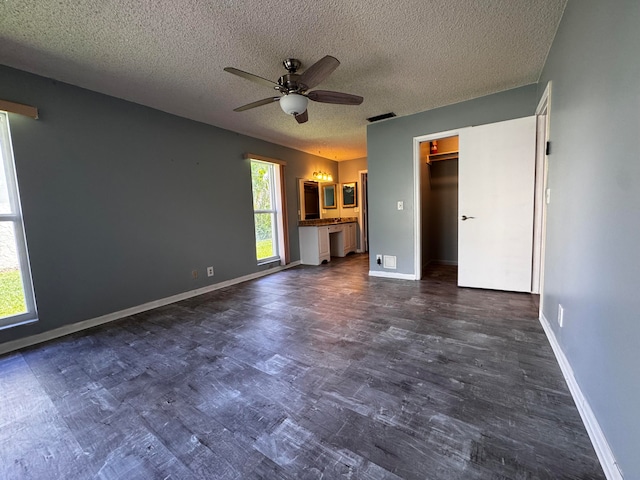 unfurnished living room featuring ceiling fan and a textured ceiling