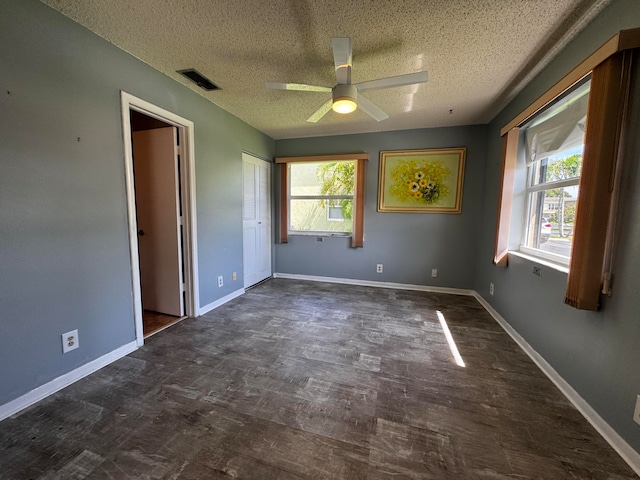 unfurnished bedroom with multiple windows, a textured ceiling, a closet, and ceiling fan