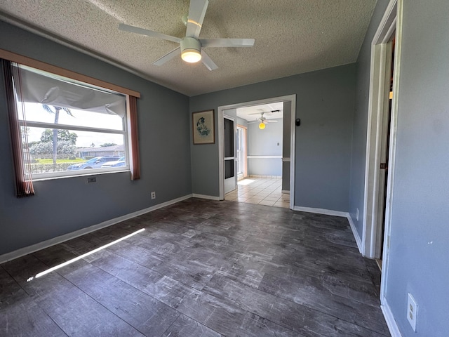 spare room with a textured ceiling and ceiling fan