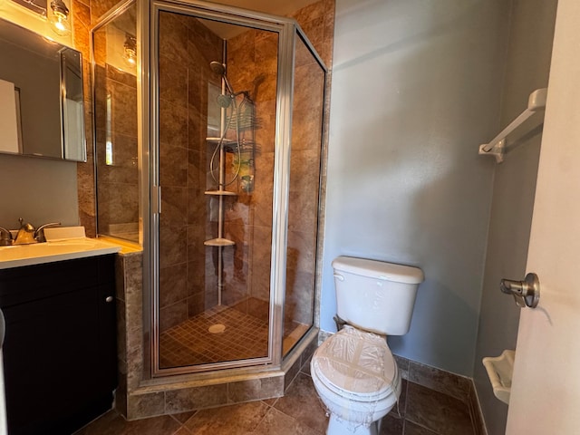 bathroom featuring vanity, toilet, tile patterned floors, and a shower with door