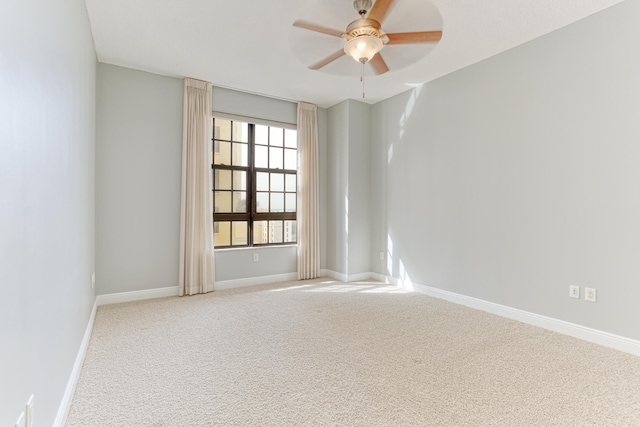 unfurnished room with ceiling fan and carpet flooring