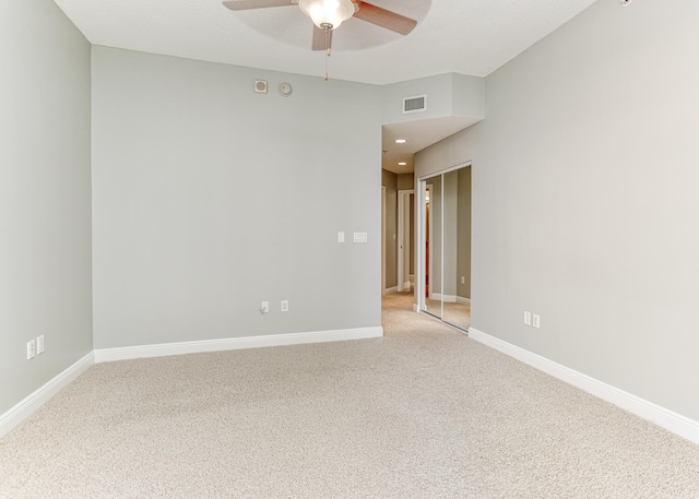 unfurnished room featuring light colored carpet and ceiling fan