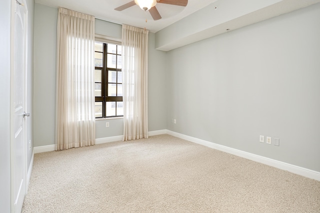 carpeted spare room with a healthy amount of sunlight and ceiling fan