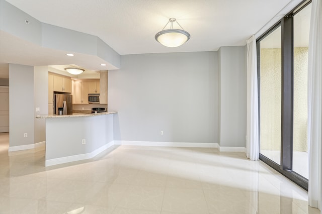 unfurnished room featuring light tile patterned flooring