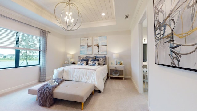 bedroom with a notable chandelier, ornamental molding, light colored carpet, and a tray ceiling