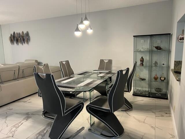 dining space featuring a notable chandelier