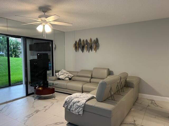 living room featuring a textured ceiling and ceiling fan