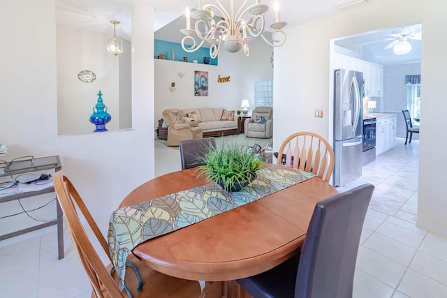 dining room featuring ceiling fan with notable chandelier and light tile patterned floors