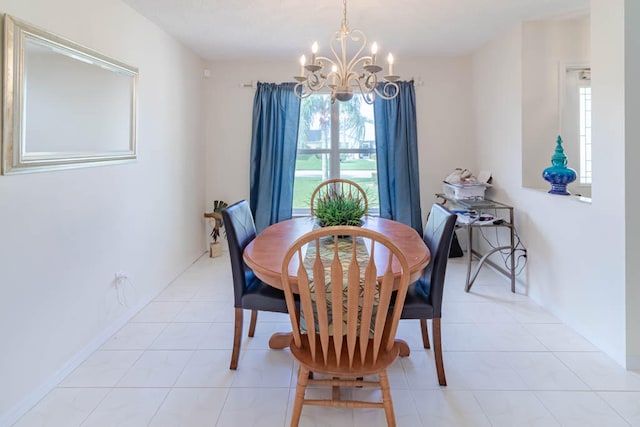 dining area featuring an inviting chandelier and light tile patterned flooring