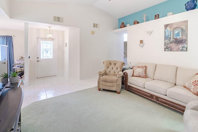 living room featuring light tile patterned flooring and vaulted ceiling