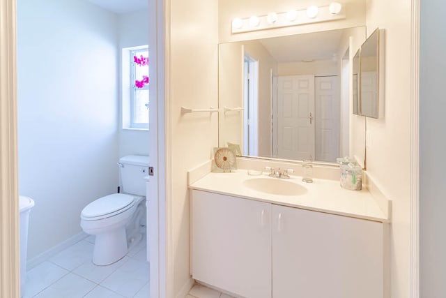 bathroom featuring tile patterned flooring, vanity, and toilet