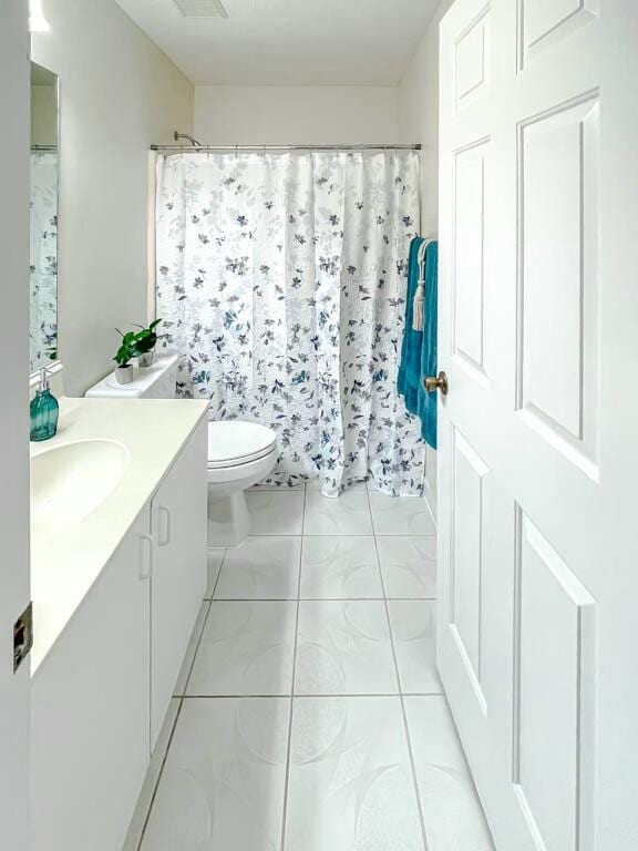 bathroom featuring tile patterned floors, vanity, and toilet