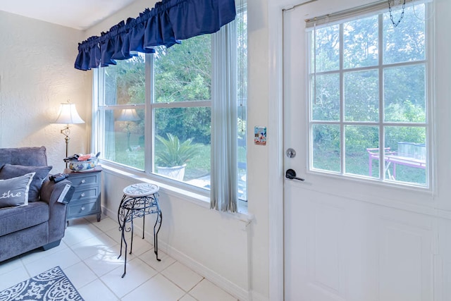 entryway with plenty of natural light and light tile patterned flooring