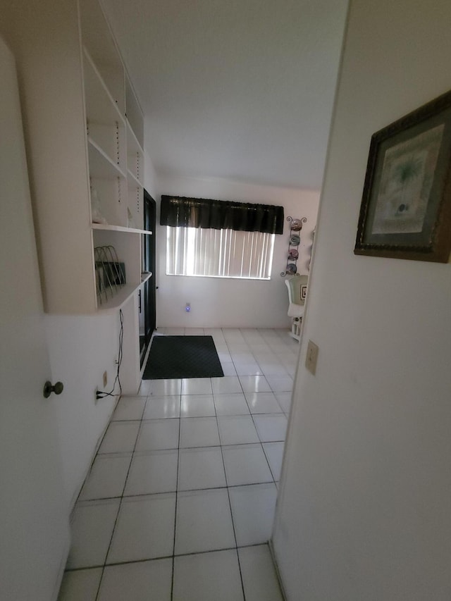 corridor featuring light tile patterned floors