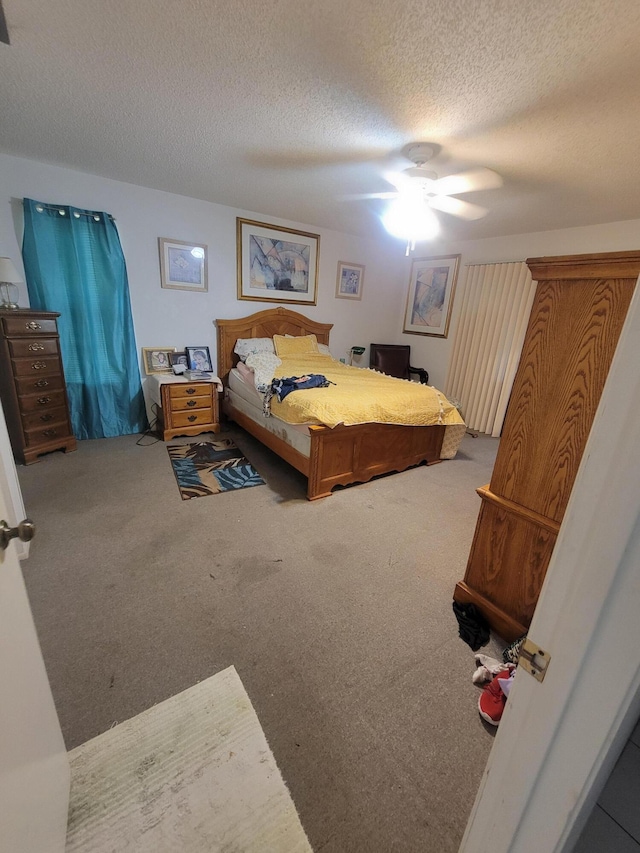 carpeted bedroom with a textured ceiling and ceiling fan