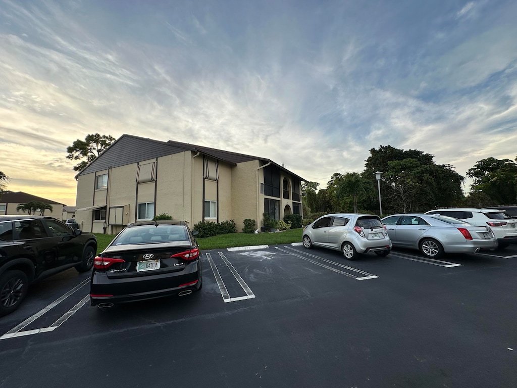 327 Pine Ridge Cir Apt B-2, Greenacres, FL 33463 - view of parking at dusk
