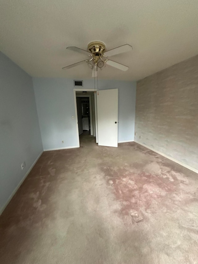 empty room featuring light colored carpet and ceiling fan