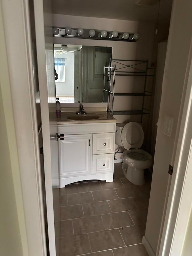 bathroom featuring vanity, ceiling fan, tile patterned flooring, and toilet