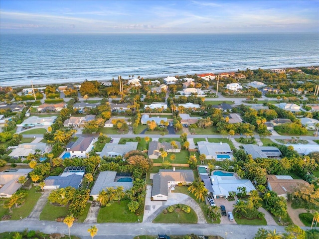 drone / aerial view with a water view and a beach view