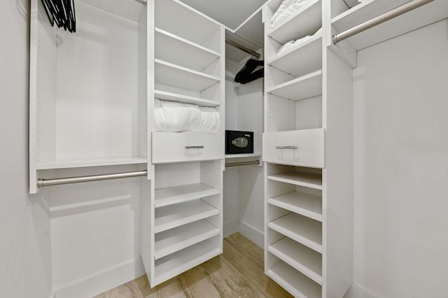 spacious closet with wood finished floors