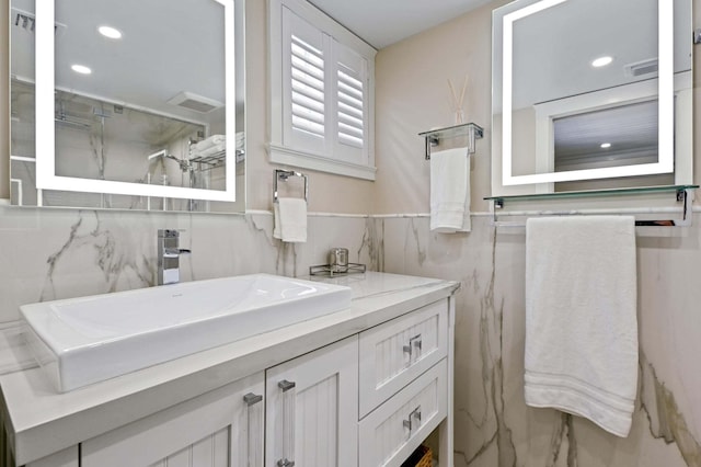 bathroom featuring a shower, visible vents, vanity, and recessed lighting