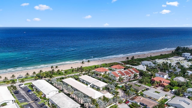 bird's eye view featuring a view of the beach, a residential view, and a water view