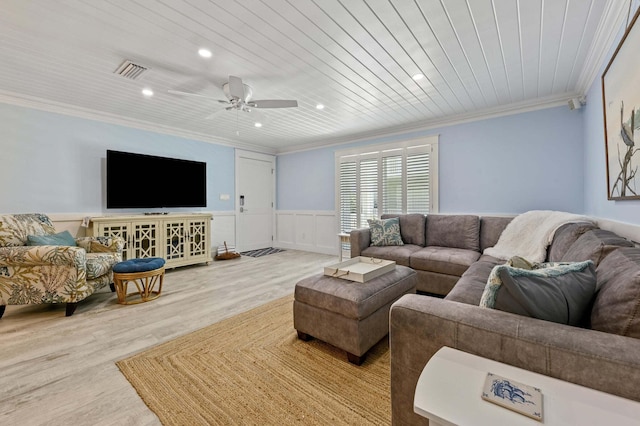 living room with visible vents, recessed lighting, ornamental molding, wood finished floors, and wainscoting
