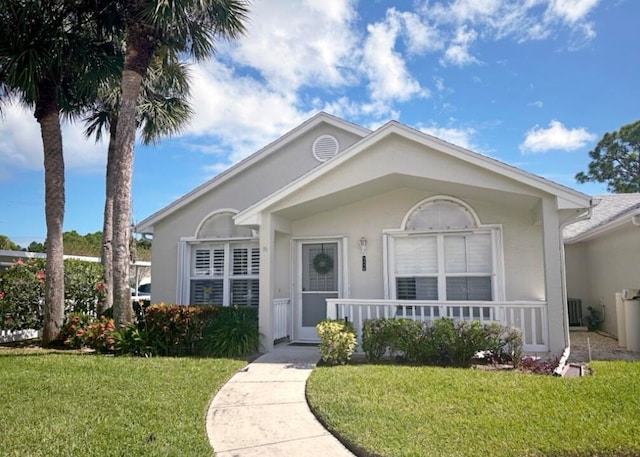 single story home with a front lawn and covered porch