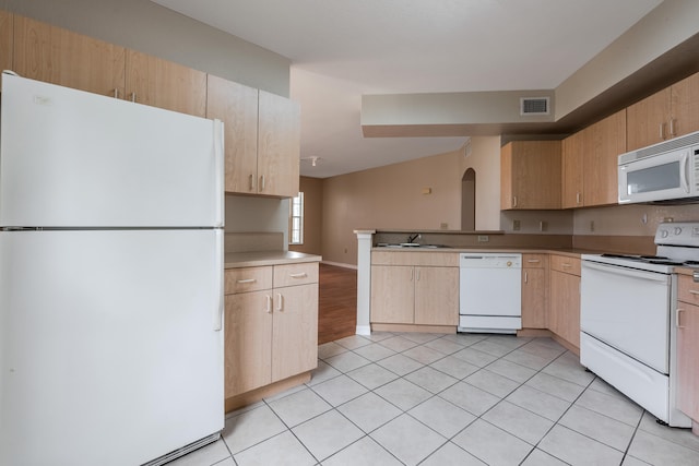 kitchen with white appliances, sink, kitchen peninsula, light tile patterned floors, and light brown cabinets