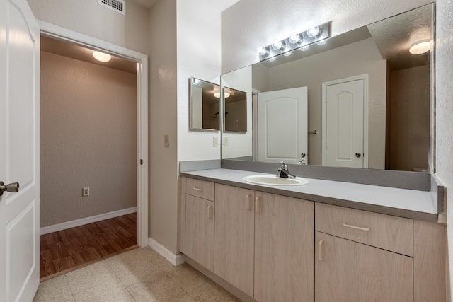 bathroom with vanity and hardwood / wood-style flooring