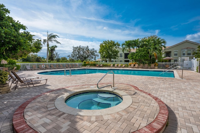 view of pool with a patio and a community hot tub